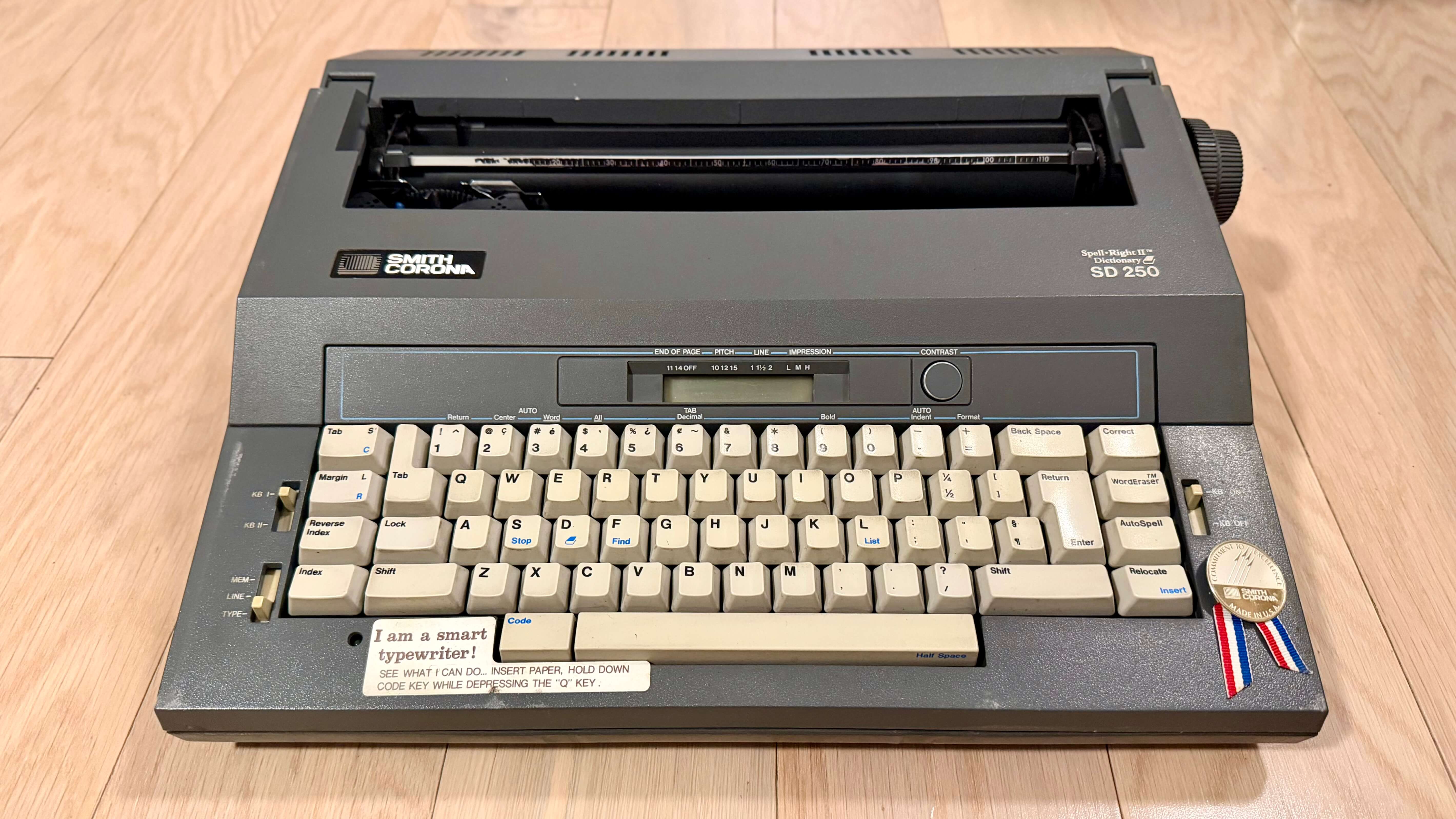 Smith Corona SD 250 electric typewriter with 'I am a smart typewriter' sticker.