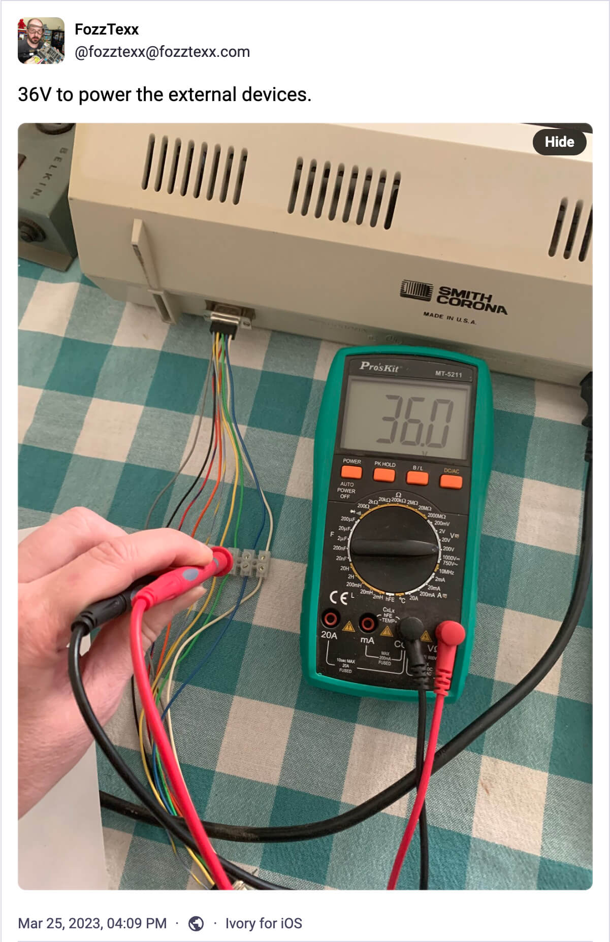 Mastodon post by FozzTexx showing a multimeter reading 36.0V on the Smith Corona DB-9 connector.